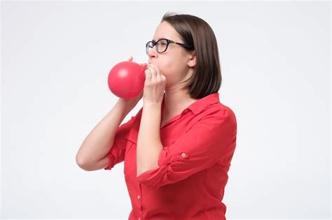 Premium Photo Mature Caucasian Woman Blowing Red Balloon Training Her