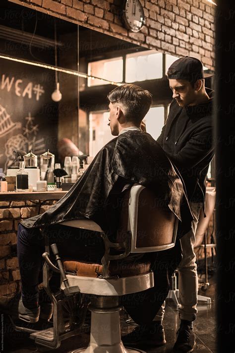 Young Barber Giving Client A Classic Haircut In Vintage Barber Shop Timeless Style