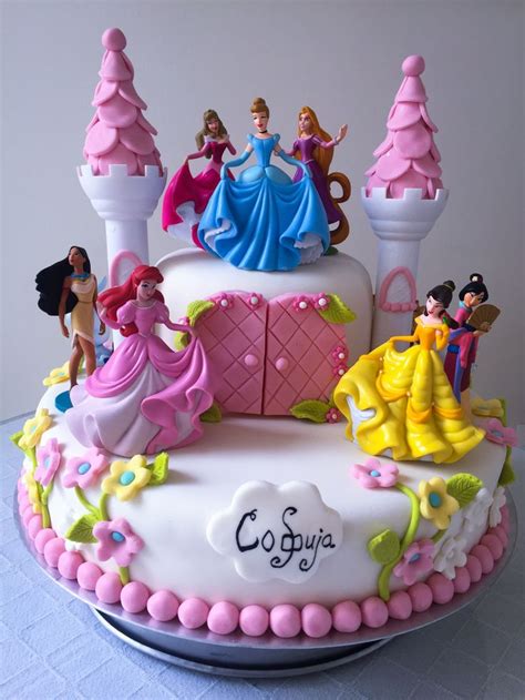 A Birthday Cake With Princess Figurines On It