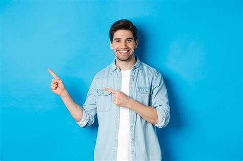 Free Photo Handsome Caucasian Man In Casual Outfit Pointing Fingers