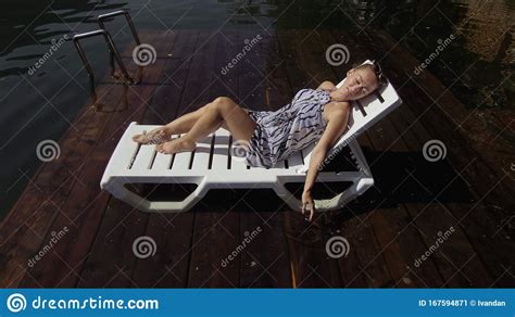 Woman Lie On A Sunbed In Sunglasses And A Boho Silk Shawl Girl Rest On