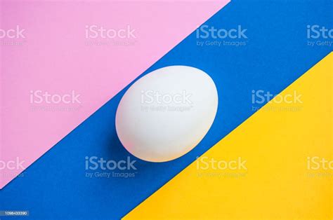 A Single Egg On Blue Background Stock Photo Download Image Now 2019