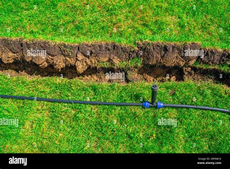 Installing A Pop Up Sprinkler In The Lawn Close Up Grass Irrigation