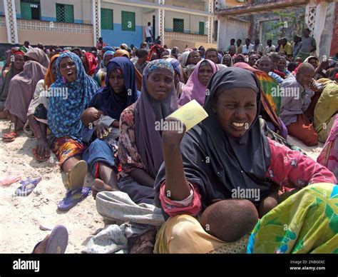 Somali Women Displaced By Drought Wait To Receive Rations At A Camp In