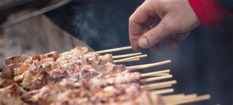 Premium Photo Meat Skewers Souvlaki On Grill Man S Hand Ready To