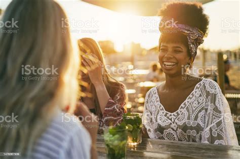 Happy Girls Having Fun Drinking Cocktails At Bar On The Beach Soft Focus On African Girl Face