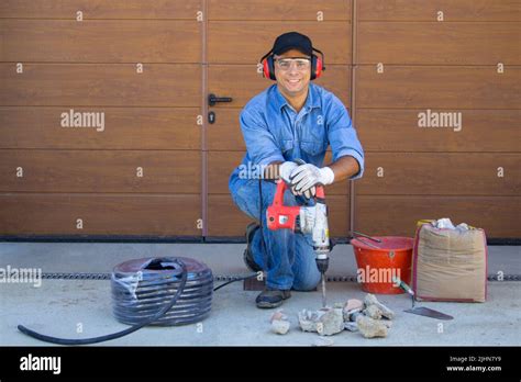 Image Of A Smiling Handyman Worker With Demolition Hammer And