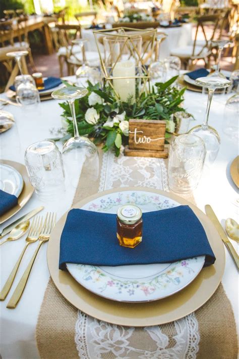 Gold Charger With Antique Plate Navy Blue Napkin And Gold Flatware Tablescape Inspiration