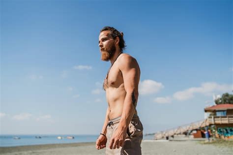 Premium Photo Handsome Bearded Man With Naked Torso On The Beach