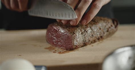 Person Cutting Beef Into Slices · Free Stock Video