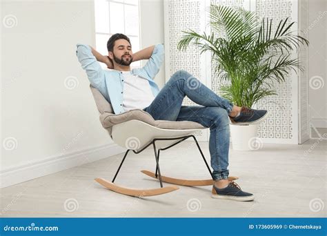 Young Man Relaxing In Rocking Chair Stock Image Image Of Eyes Calm