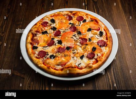 Pepperoni Mushroom Black Olives Tomato And Cheese Pizza Wooden