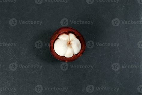 Purple mangosteen fruit pealed half on black background 24559831 Stock ...