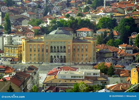 Cityscape Of Sarajevo City Hall With Traditional Buildings And Trees In