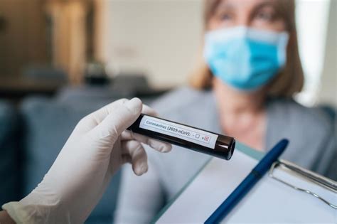 Premium Photo Two Female Doctors With Protective Clothes Holds Test