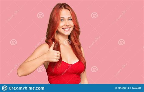 Young Redhead Woman Wearing Casual Clothes Doing Happy Thumbs Up