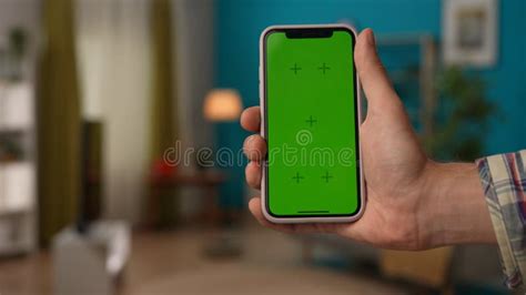 Man Hand Holding Smartphone With Chroma Key Green Screen Advertising