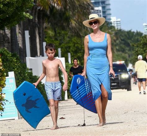 A Happy Family Strolling Barefoot on the Beach