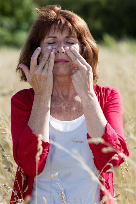 S Brunette Woman Massaging Face To Soothe Sinus Pain Outdoors Stock Photo Image Of Hair