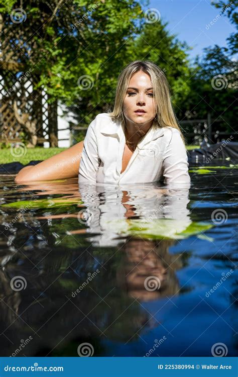 A Lovely Blonde Model Poses In Lingerie Outdoors In A Pool Of Water Stock Photo Image Of