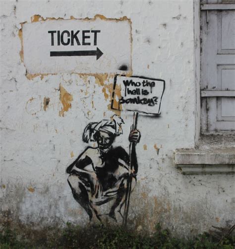 a painting on the side of a building that says ticket and what do you ...