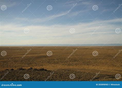 Barren Landscape In The Desert Featuring Sand Dunes And Patches Of