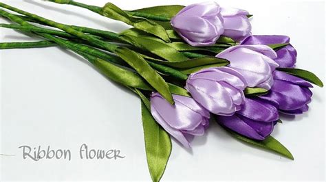 Purple Flowers With Green Stems On A White Surface