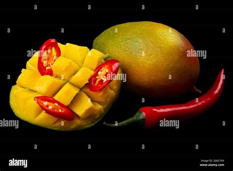 Diced Half Of Mango Hot Chili Pepper Rings Whole Red Hot Pepper And Whole Mango On Pure Black