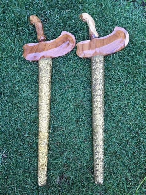 Two Wooden Walking Canes Sitting On Top Of Green Grass