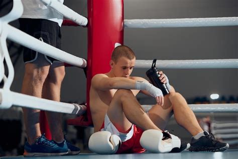 Premium Photo | Prefight consultation young boxer training with ...