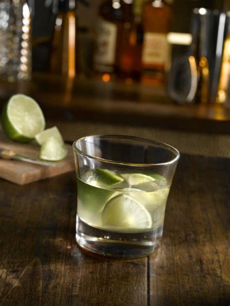 A Glass Filled With Green Liquid And Lime Slices