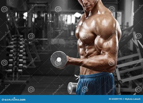 Muscular Man Working Out In Gym Doing Exercises With Dumbbells At Biceps Strong Male Naked