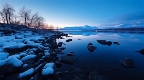 Premium AI Image | Winter Sunset Over Snowy Lake With Mountain In ...