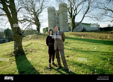 Alan Clark, diarist and historian with his wife Jane in the grounds of Saltwood Castle, their ...