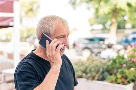 Old Man Talking With The Mobile Phone In The Street Stock Photo Image