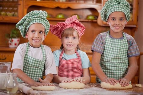 Three Young Children Make A Mess In The Kitchen Stock Photo Image Of