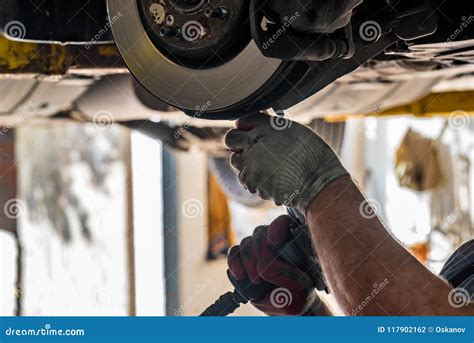 Changing brake pad on car stock photo. Image of home - 117902162