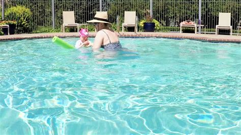 Slow Motion Pov Point Of View Mother And Daughter Swimming In Outdoor Swimming Pool Stock