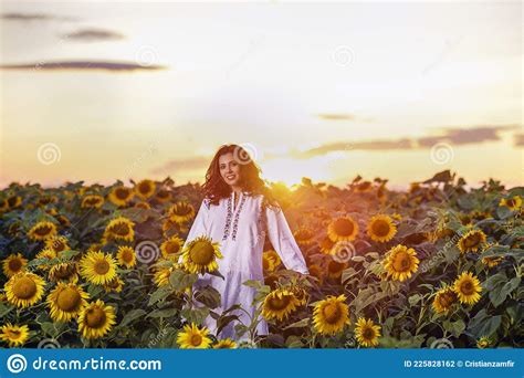 Beautiful Woman Enjoying Nature In The Sunflower Field At Sunset