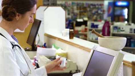 Pharmacist Making Prescription Record On Computer Stock Footage