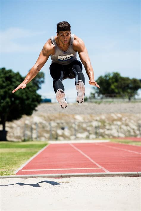 Athlete Performing A Long Jump Stock Image Image Of Number Field