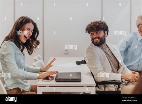 Brunette Woman Reacting To Good News At Work That Her Disabled Male Colleague Told To Her Stock