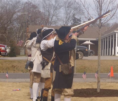 Sons Of The American Revolution Perform A Firing Salute To The Fallen