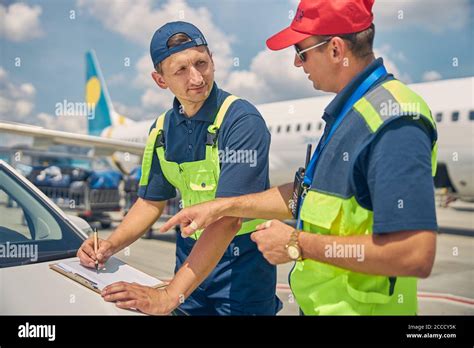 Qualified technicians making an aircraft maintenance checklist Stock Photo - Alamy