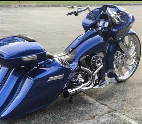 A Blue Motorcycle Parked On Top Of A Parking Lot