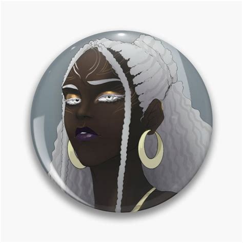 a button with an image of a woman's face and ear rings on it