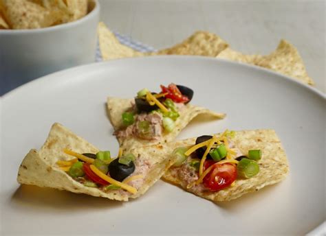 Taco Dip combines salsa and sour cream and is topped with fresh veggies.