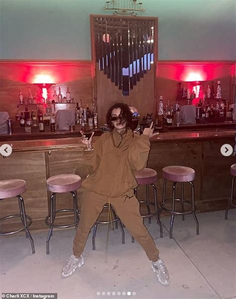 Charli XCX Shows Off Her Figure In A Plunging Purple Bikini Daily