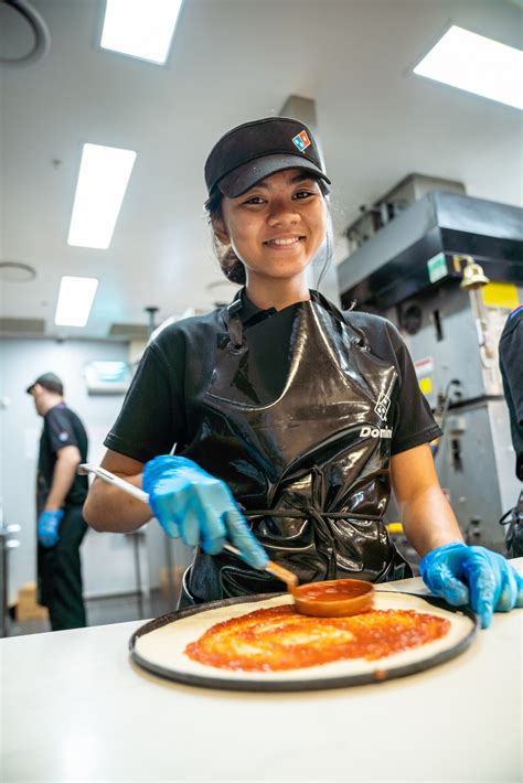 Workers react as career dominos updates its training program today 3