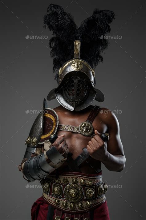 Aggressive Roman Gladiator Of African Ethnic Against Grey Background